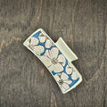 Hand-painted wood hair claw clip featuring large white hibiscus blooms on a blue-painted wood background