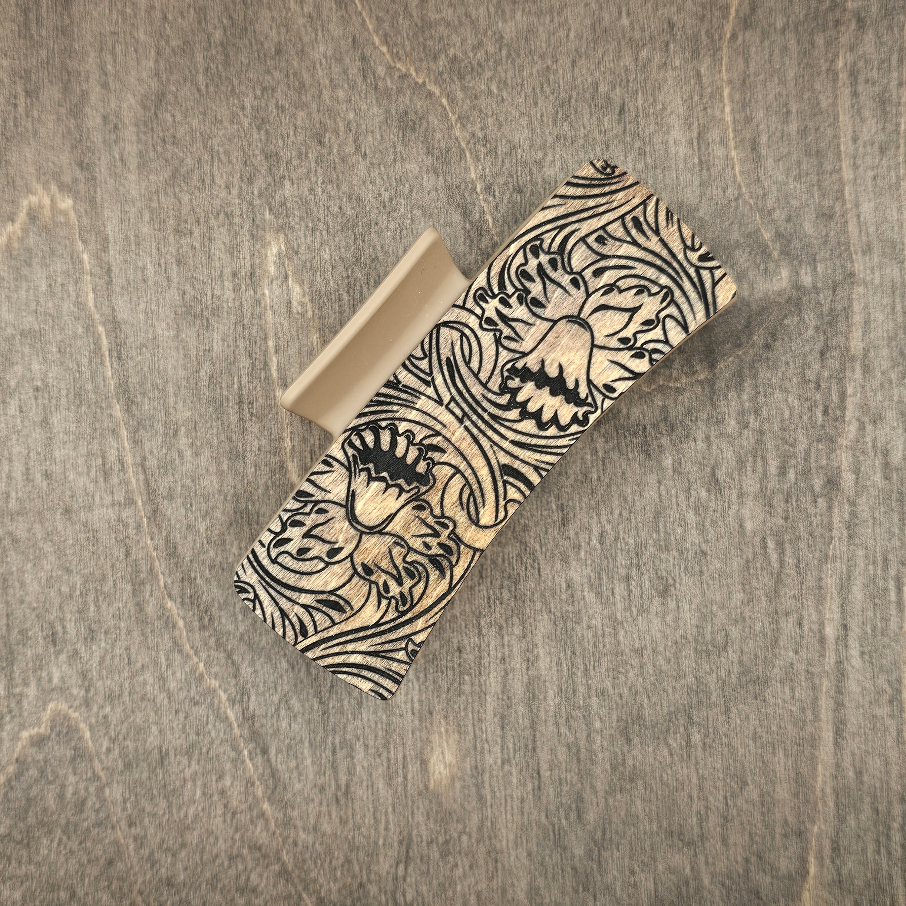 Hand-stained wood hair claw clip featuring a laser-engraved western daffodil with intricate scrollwork on a natural wood background