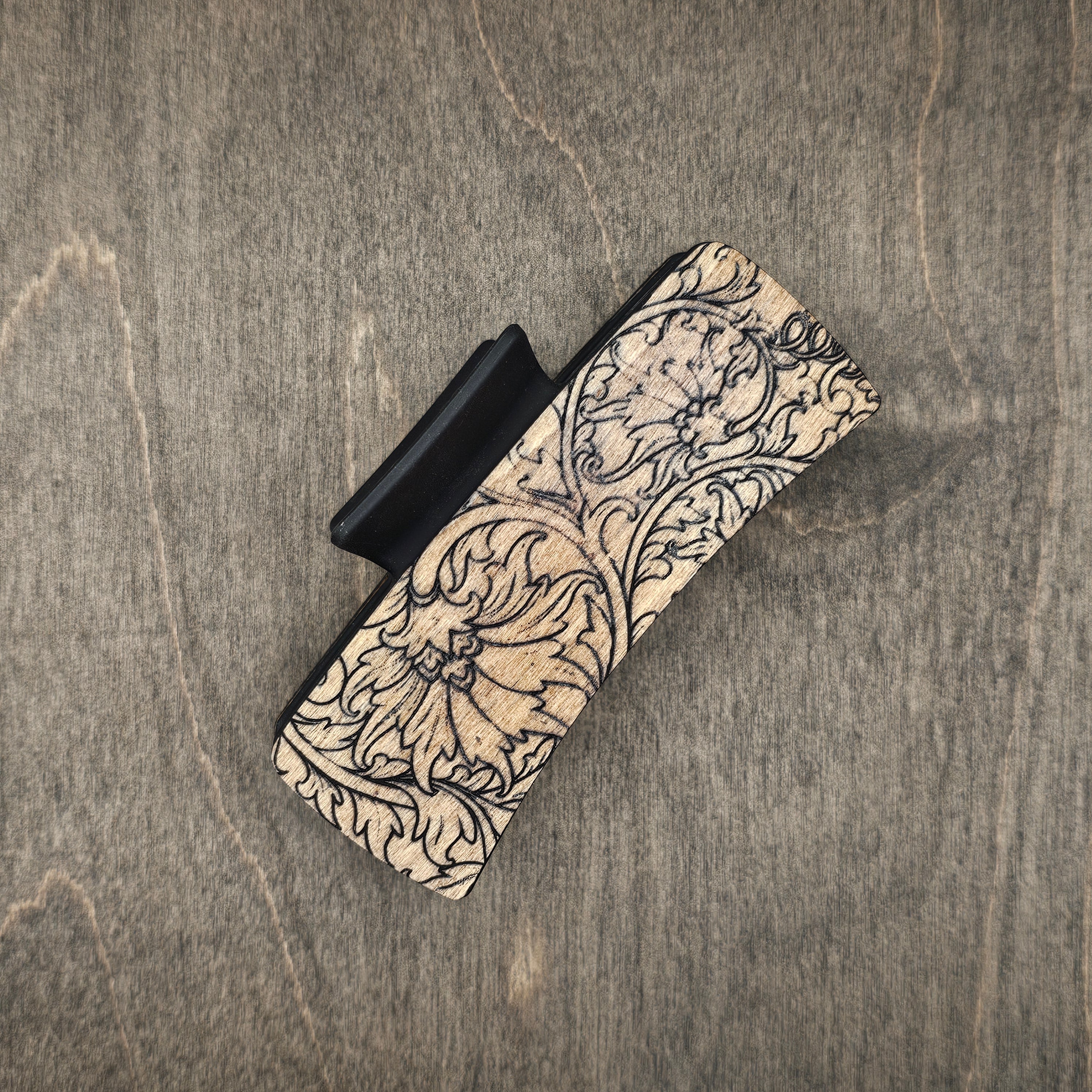Hand-stained wood hair claw clip featuring a laser-engraved western wild rose with intricate scrollwork on a natural wood background