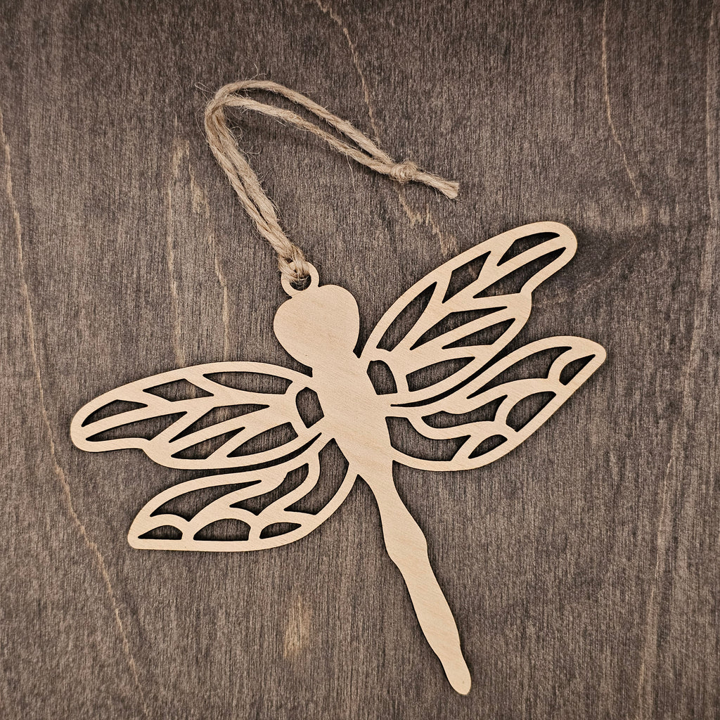 Laser cut dragonfly wood ornament with intricate lattice wing cutwork design, hung with natural jute cord