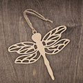 Laser cut dragonfly wood ornament with intricate lattice wing cutwork design, hung with natural jute cord