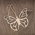 Laser cut wood butterfly ornament with intricate layered wing cutwork design, hung with natural jute cord