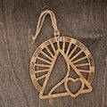 Laser cut wood recovery ornament with open sunburst design engraved with Serenity, Courage, Wisdom, and One Day at a Time, with a heart cutout at the center, hung with natural jute cord