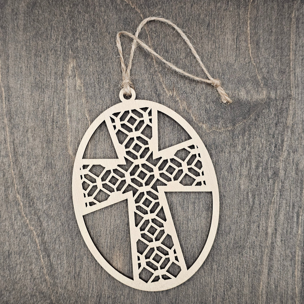 Laser cut Faith Over Fear cross wood ornament with intricate geometric lattice pattern inside an oval wood frame, hung with natural jute cord