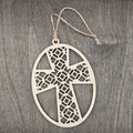 Laser cut Faith Over Fear cross wood ornament with intricate geometric lattice pattern inside an oval wood frame, hung with natural jute cord