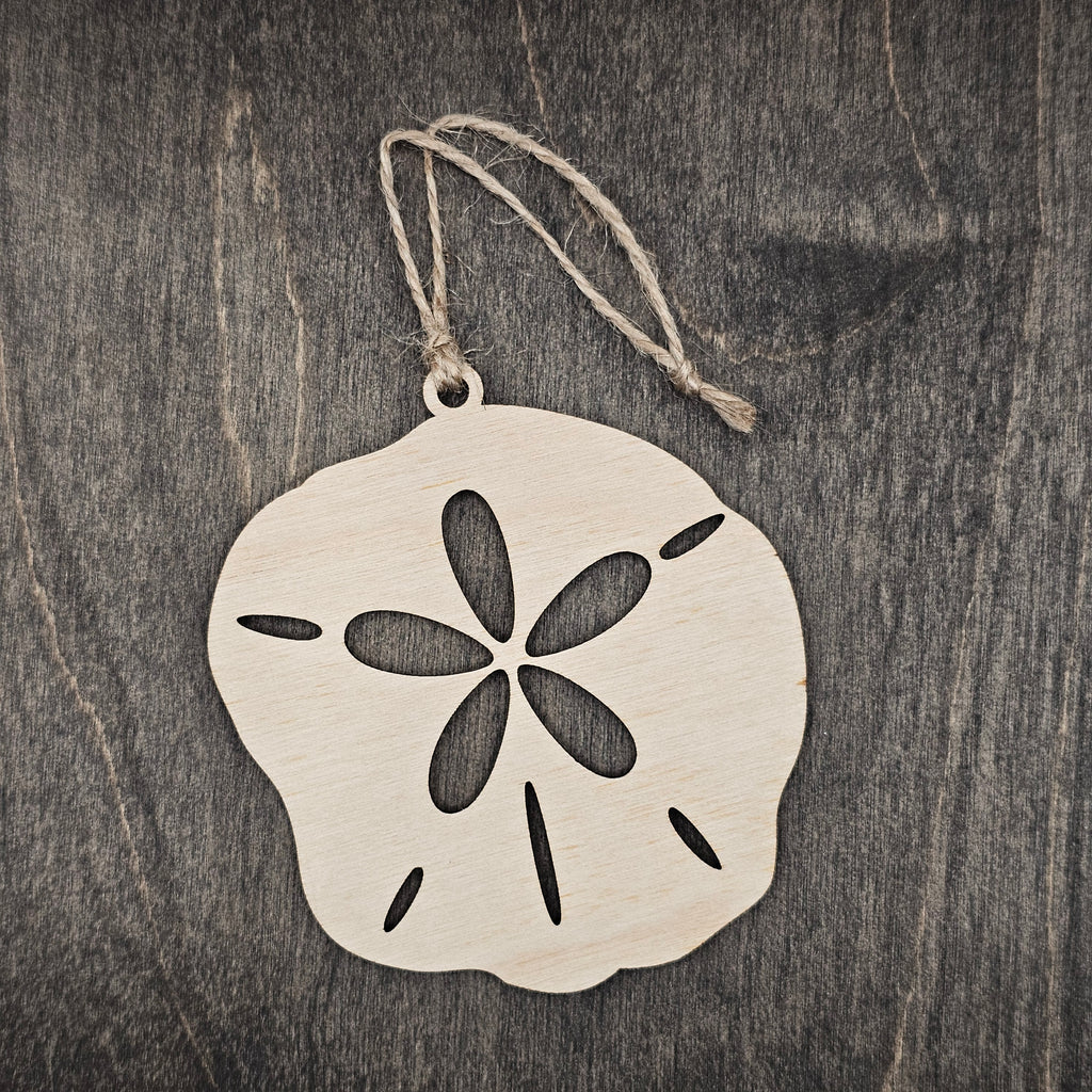 Laser cut wood sand dollar ornament with five-petal cutout and authentic slit detail, hung with natural jute cord