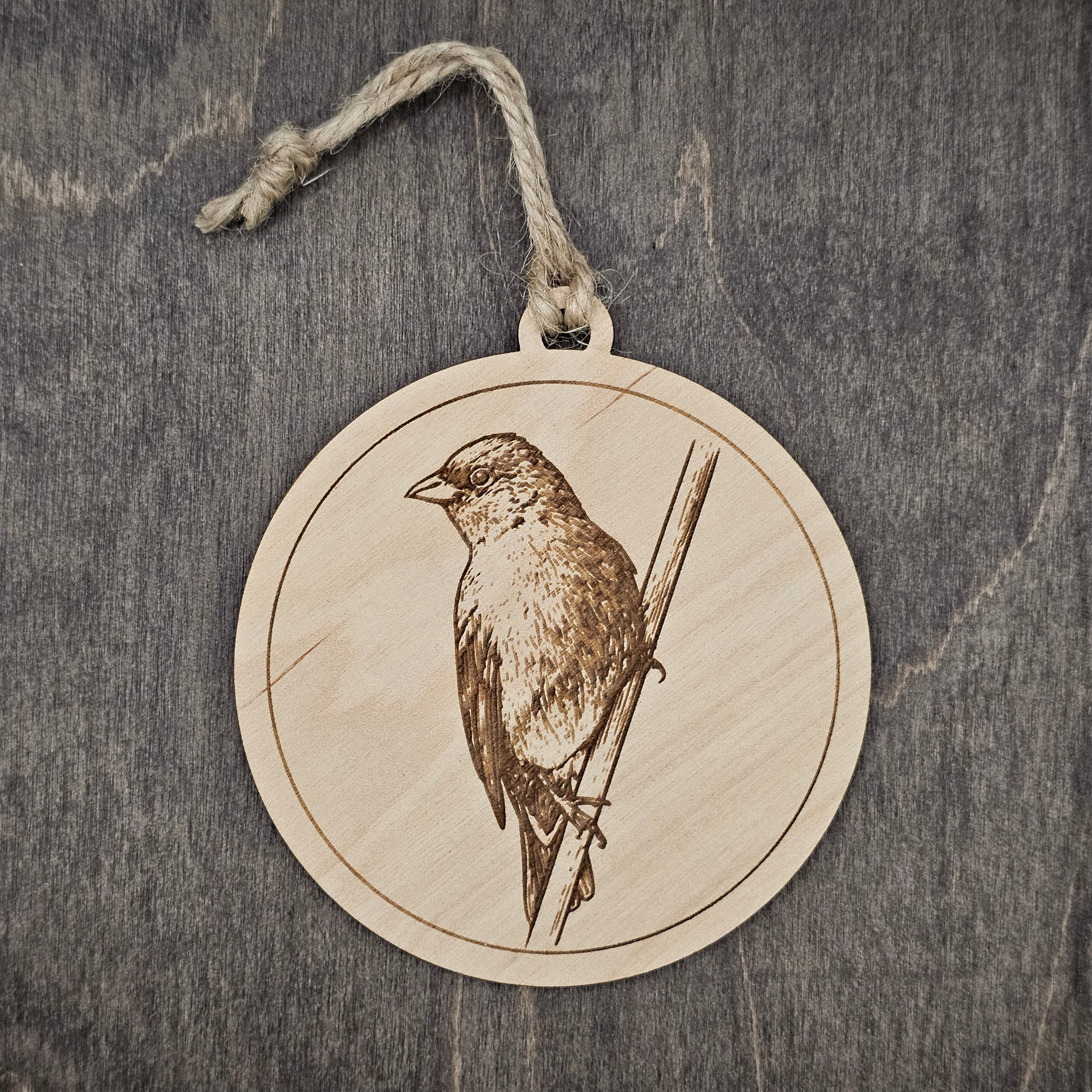 Laser engraved Indigo Bunting wood ornament with detailed engraved illustration, hung with natural jute cord
