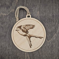 Laser engraved Scissor-tailed Flycatcher wood ornament, featuring a detailed illustration of Texas's state bird captured in full flight with its iconic forked tail, hung with natural jute cord