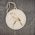 Laser engraved Gray Vireo wood ornament with detailed engraved illustration, perched on a bare branch, hung with natural jute cord