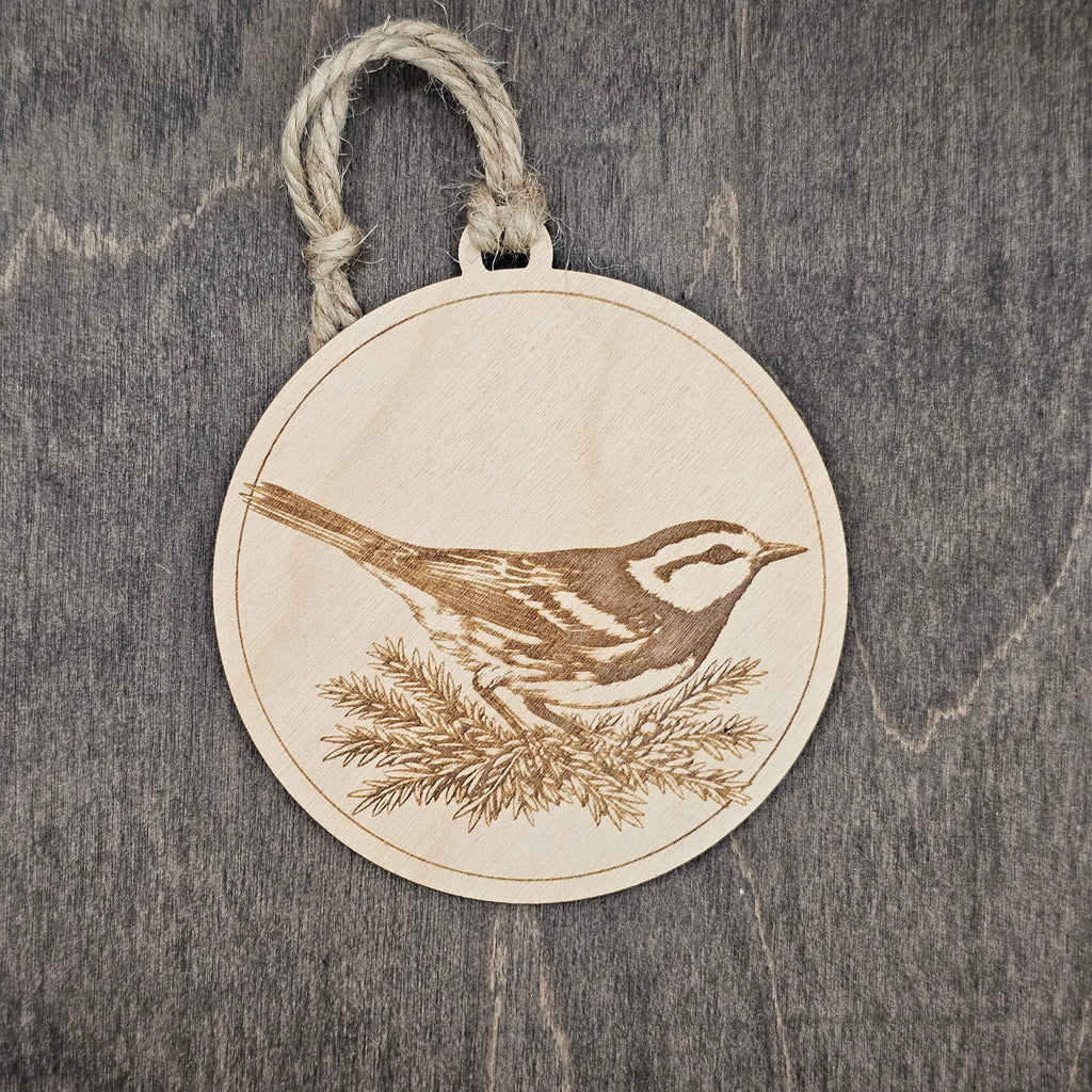 Laser engraved Golden-cheeked Warbler wood ornament, featuring a detailed illustration of this endangered Texas songbird nestled among juniper foliage, hung with natural jute cord