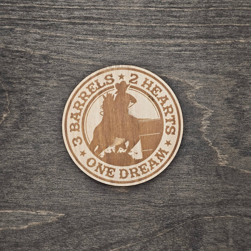Round laser-engraved wood magnet with barrel racer and horse silhouette, reading 3 Barrels 2 Hearts One Dream